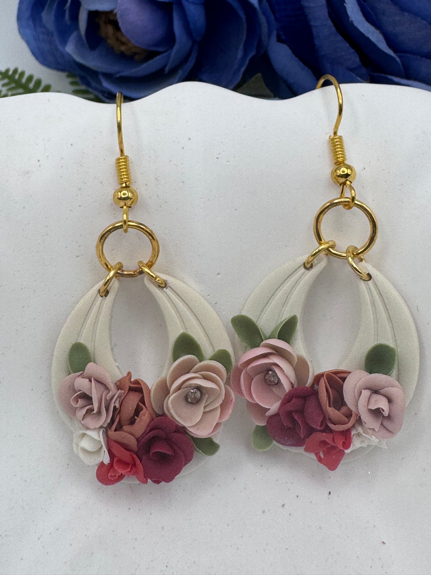 Floral earrings with gold hooks on a white background