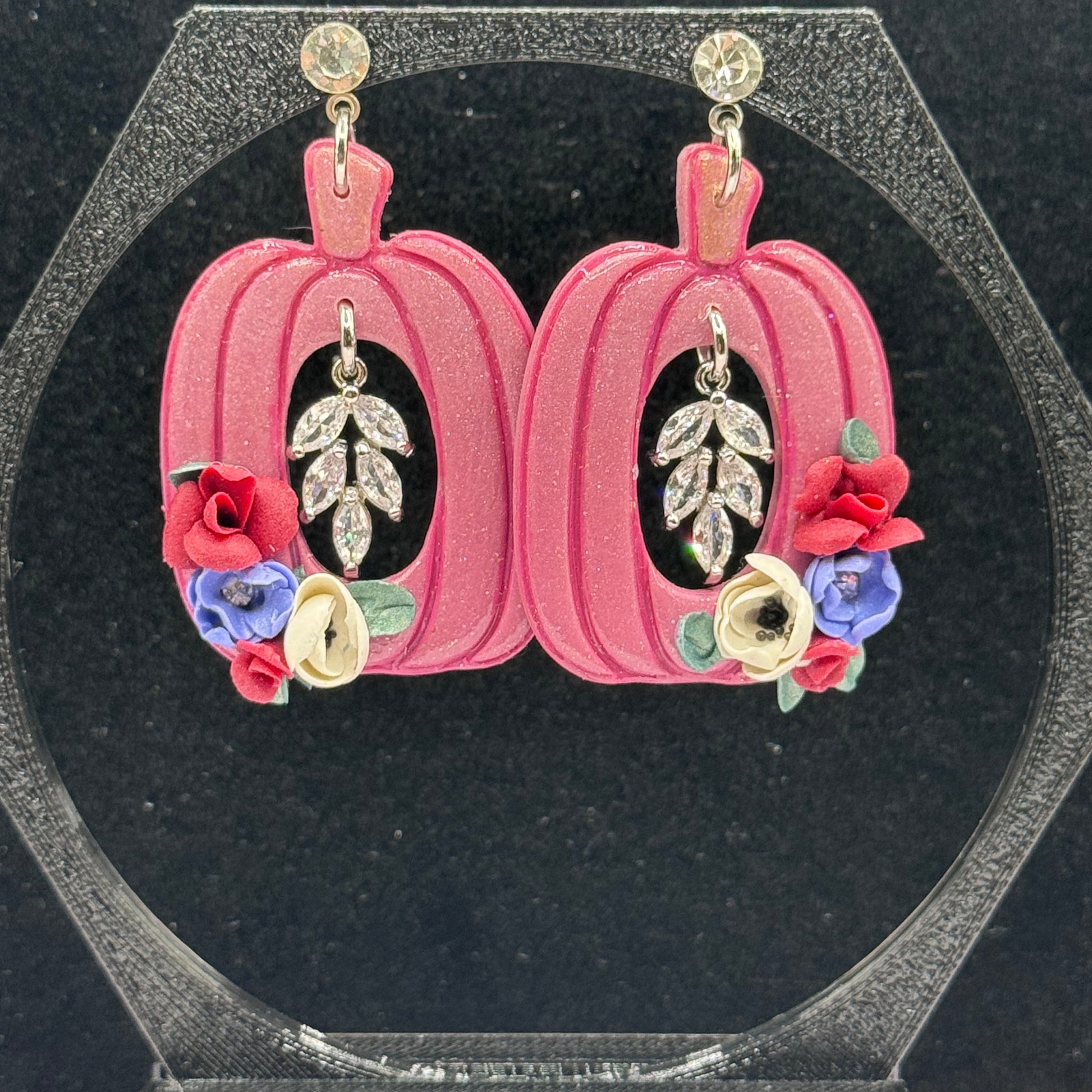 Pink Pumpkin with floral and leaf designs on a black background